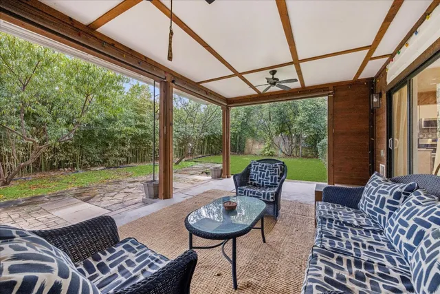 a living room with furniture and a floor to ceiling window