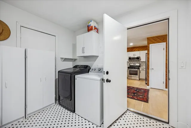 a kitchen with a refrigerator and cabinets