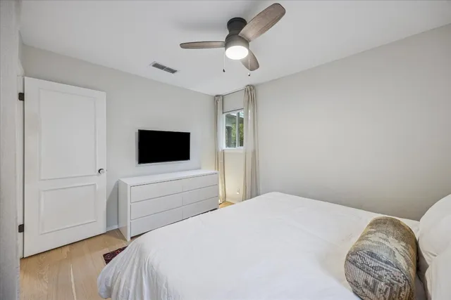 a bedroom with a bed and a flat screen tv