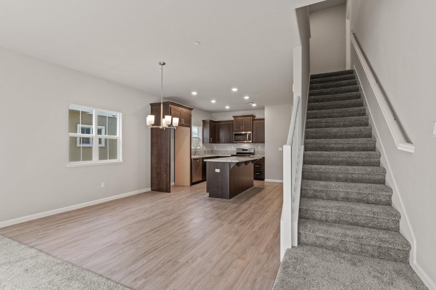 3916 Wickman Loop Rocklin, CA 95677 - Photo 20 of 40 a kitchen with stainless steel appliances kitchen island wooden cabinets and a fireplace