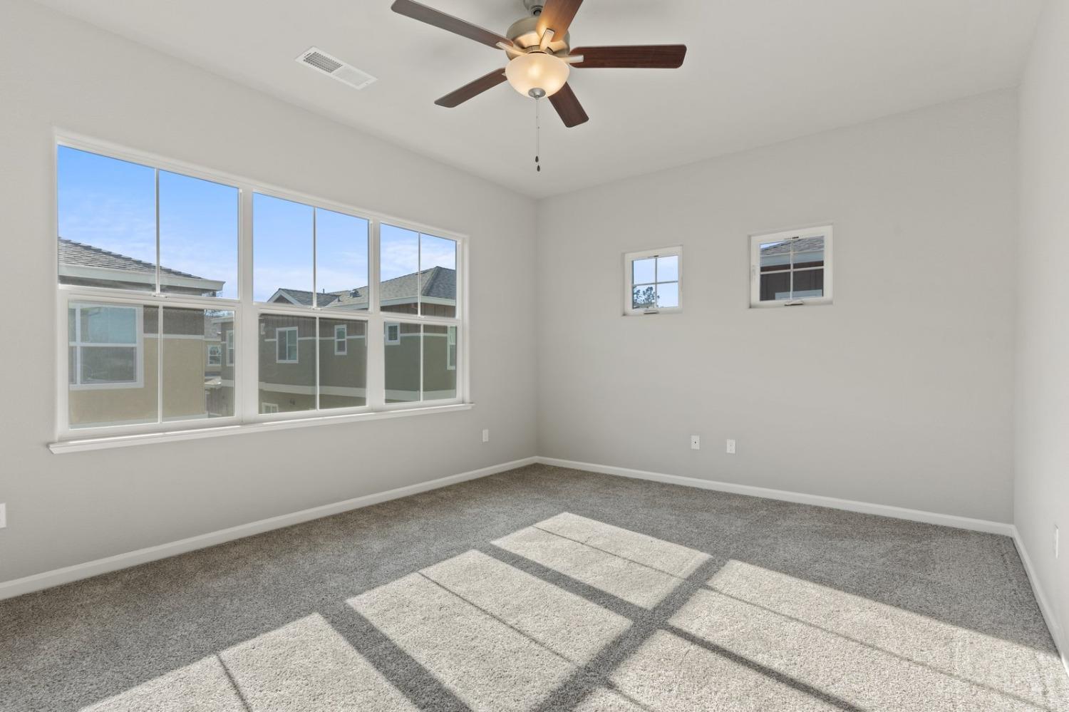 3916 Wickman Loop Rocklin, CA 95677 - Photo 31 of 40 a view of an empty room with a window and a ceiling fan