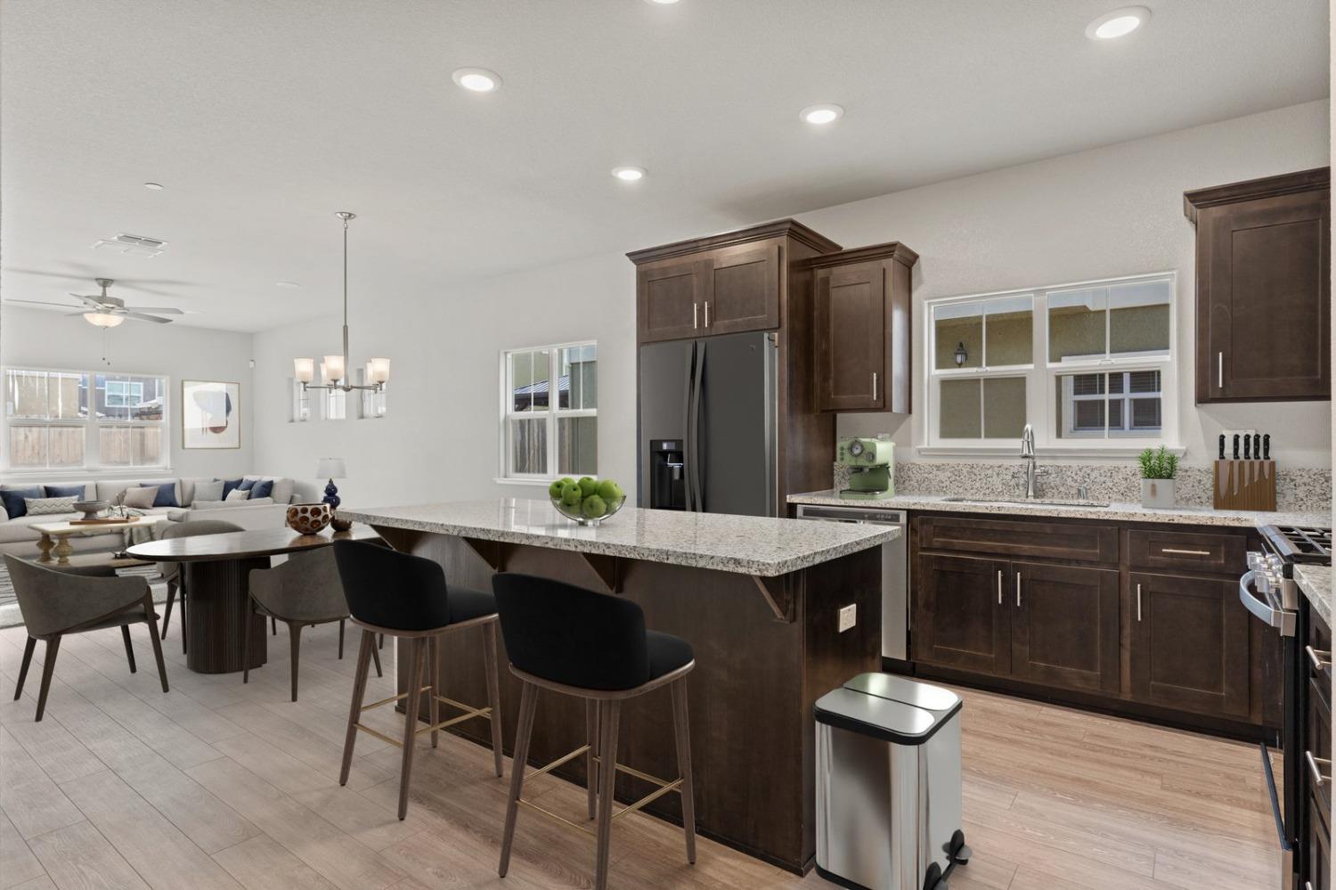 3916 Wickman Loop Rocklin, CA 95677 - Photo 6 of 40 a kitchen with a sink cabinets and dining table