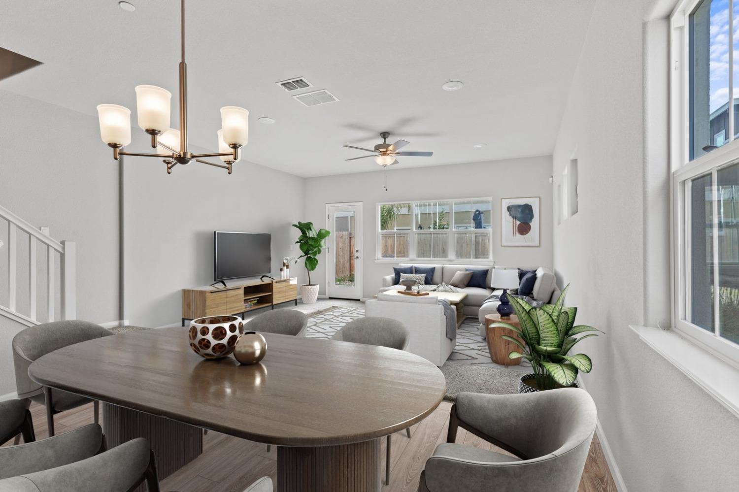 3916 Wickman Loop Rocklin, CA 95677 - Photo 9 of 40 a living room with furniture a chandelier and a flat screen tv