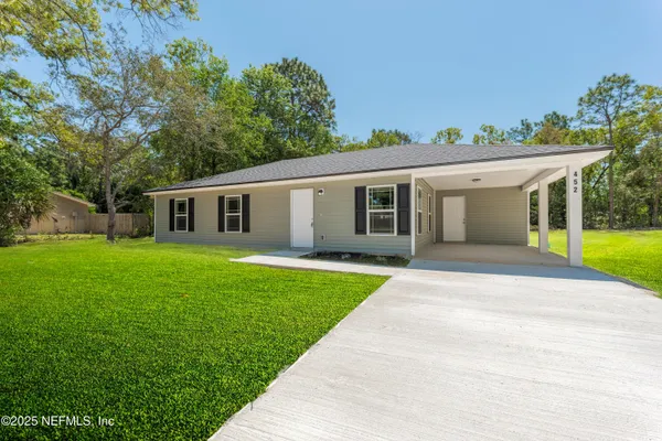 a view of a house with a backyard
