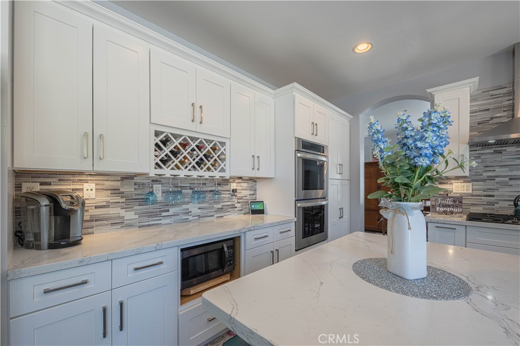 429 Tudor Way Salinas, CA 93906 - Photo 9 of 41 a kitchen with stainless steel appliances kitchen island granite countertop a refrigerator a stove and white cabinets