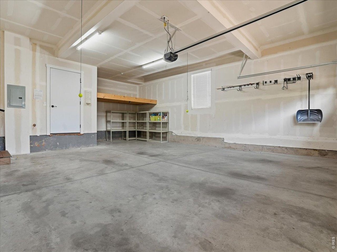 2065 Scarecrow Road Fort Collins, CO 80525 - Photo 38 of 50 Oversized 2 car garage with deep storage area and shelving