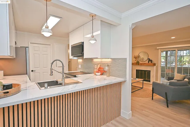 a kitchen with a sink appliances and cabinets