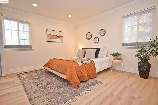 a bedroom with a bed and a potted plant