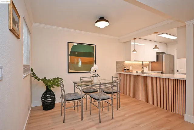 a dining room with furniture and wooden floor