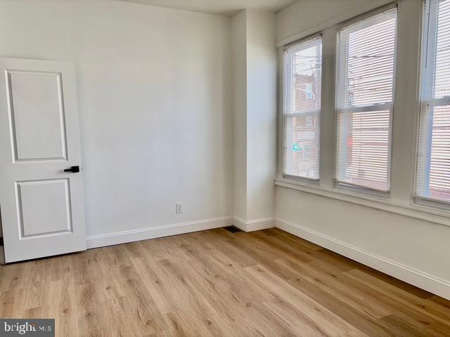 1817 South 5th Street Philadelphia, PA 19148 - Photo 16 of 23 a view of an empty room with wooden floor and a window