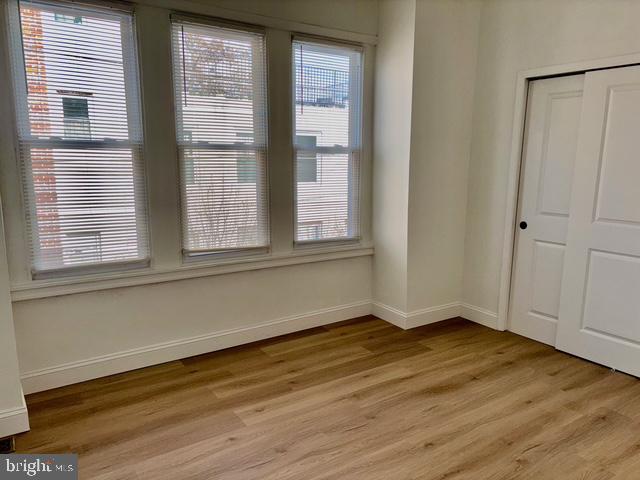 1817 South 5th Street Philadelphia, PA 19148 - Photo 17 of 23 a view of an empty room with wooden floor and a window