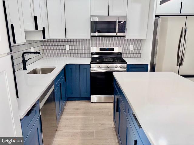 1817 South 5th Street Philadelphia, PA 19148 - Photo 3 of 23 a kitchen with a sink a stove top oven and wooden floor