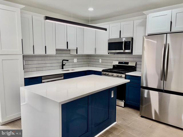 1817 South 5th Street Philadelphia, PA 19148 - Photo 4 of 23 a kitchen with stainless steel appliances a refrigerator sink and cabinets