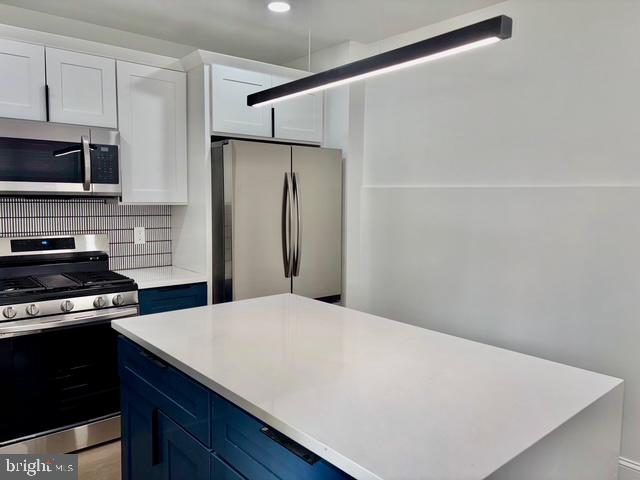 1817 South 5th Street Philadelphia, PA 19148 - Photo 5 of 23 a kitchen with a refrigerator and a stove top oven