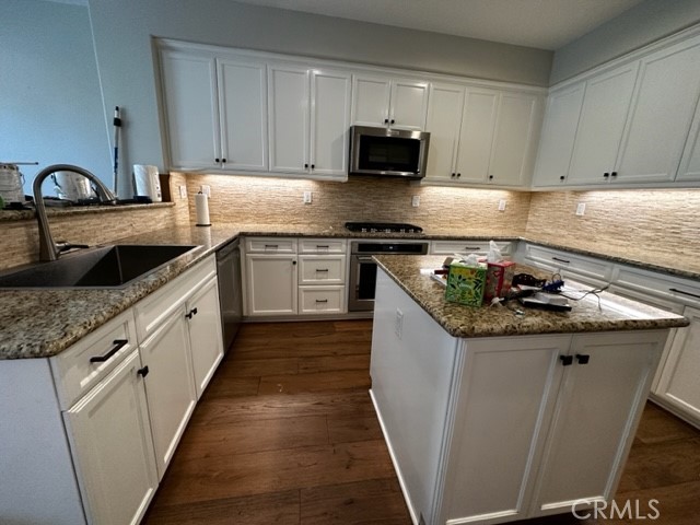 11 Corte Javier San Clemente, CA 92673 - Photo 11 of 30 a kitchen with granite countertop a sink and cabinets