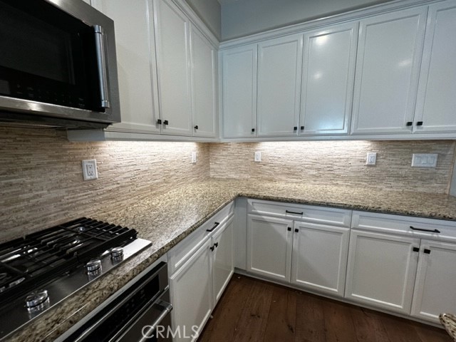 11 Corte Javier San Clemente, CA 92673 - Photo 9 of 30 a kitchen with granite countertop white cabinets and stainless steel appliances