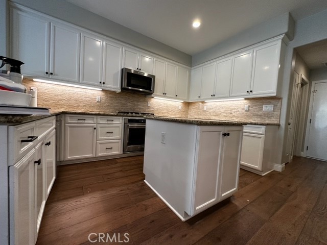 11 Corte Javier San Clemente, CA 92673 - Photo 10 of 30 a kitchen with stainless steel appliances granite countertop a stove top oven a sink dishwasher and a refrigerator