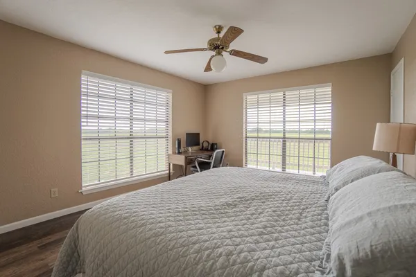 a bedroom with a large bed and a large window