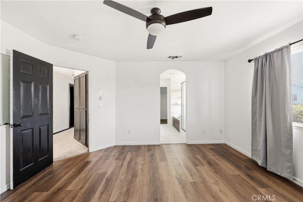 84 Jack Court Merced, CA 95341 - Photo 18 of 34 a view of empty room with wooden floor and fan