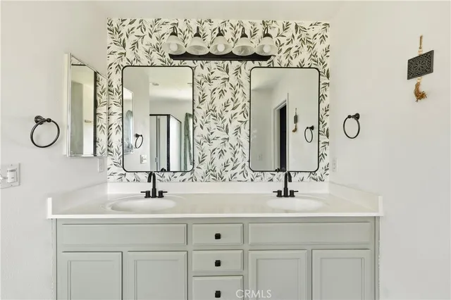 a bathroom with a double vanity sink and a mirror
