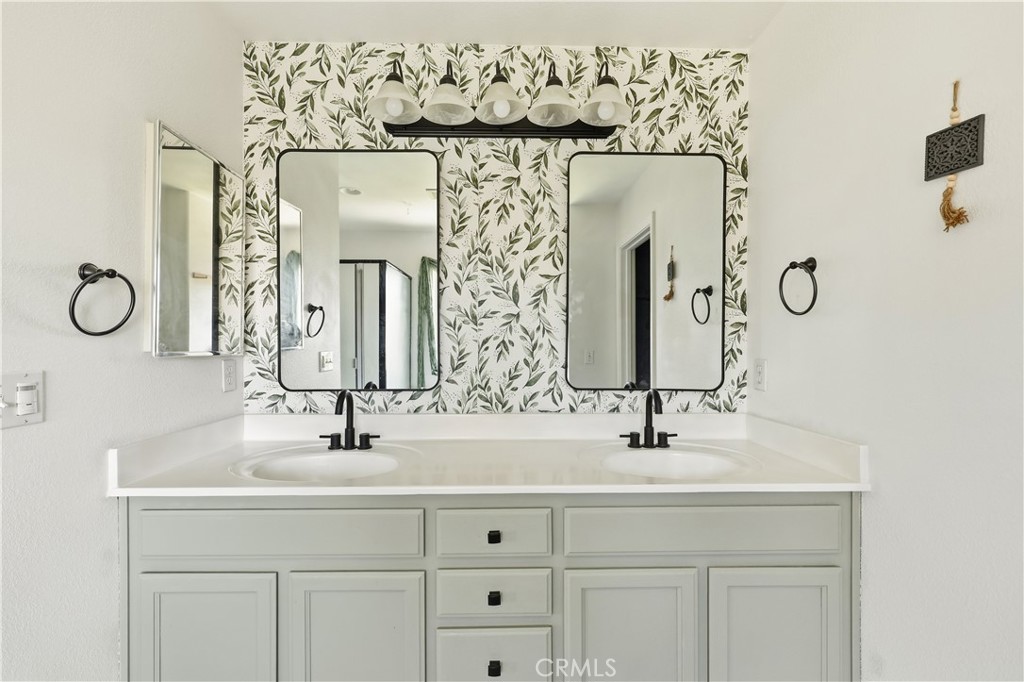 84 Jack Court Merced, CA 95341 - Photo 20 of 34 a bathroom with a double vanity sink and a mirror
