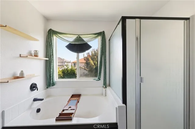 a bathroom with a tub and shower