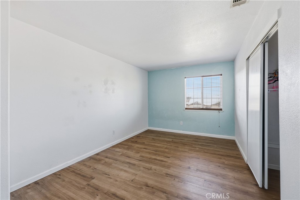 84 Jack Court Merced, CA 95341 - Photo 24 of 34 wooden floor in an empty room with a window