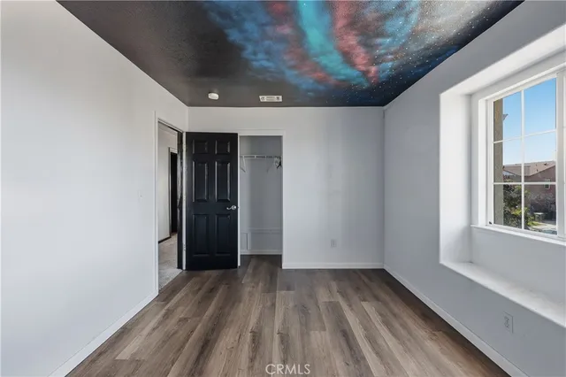 a view of hallway with wooden floor and entryway