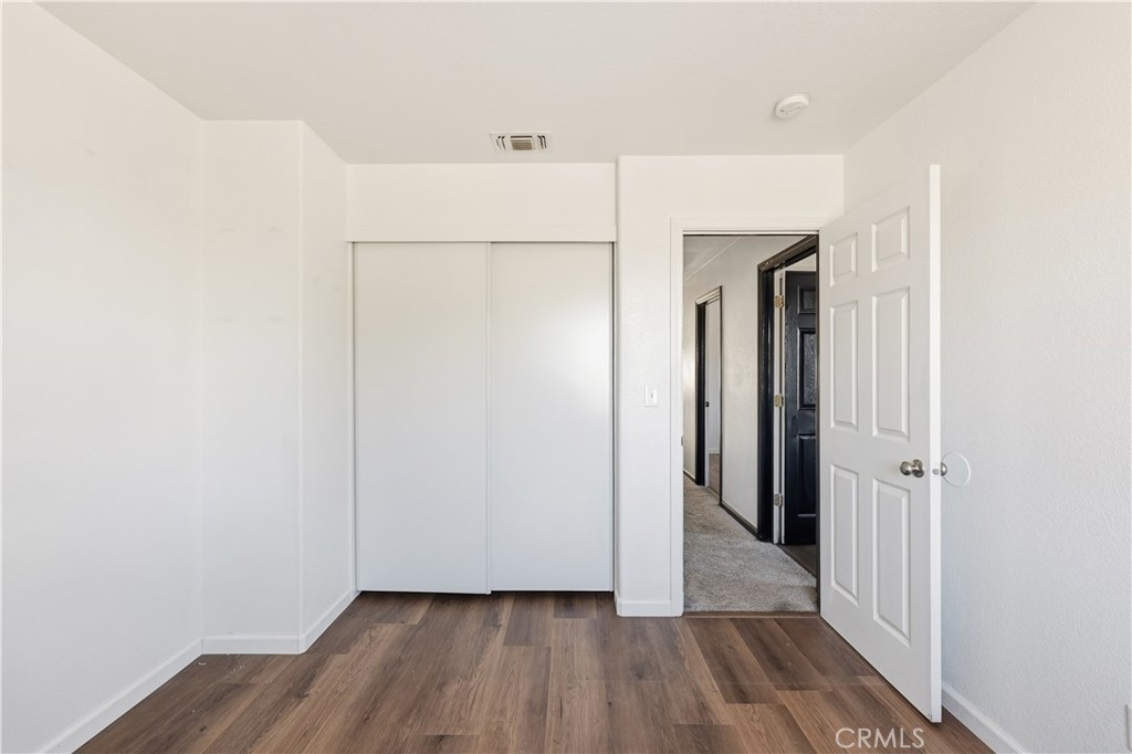 84 Jack Court Merced, CA 95341 - Photo 31 of 34 a view of a hallway with wooden floor