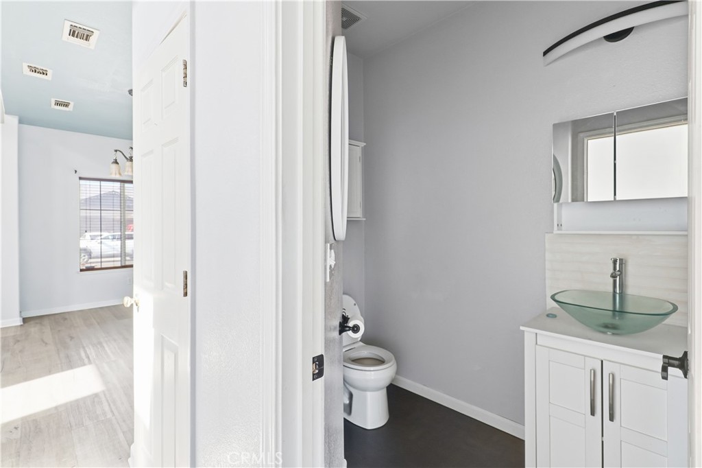 84 Jack Court Merced, CA 95341 - Photo 7 of 34 a bathroom with a toilet a sink and mirror