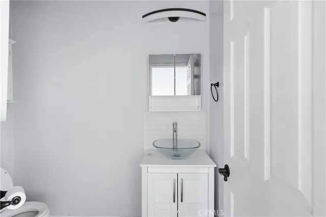 a bathroom with a sink a toilet and vanity