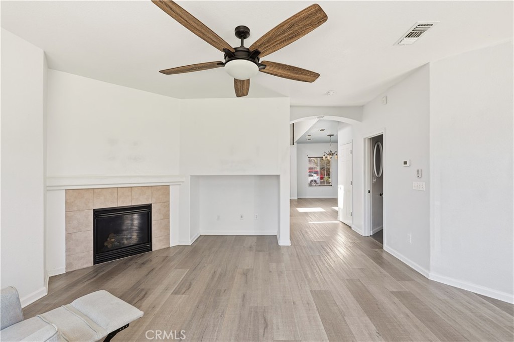 84 Jack Court Merced, CA 95341 - Photo 10 of 34 a view of empty room with wooden floor and fireplace