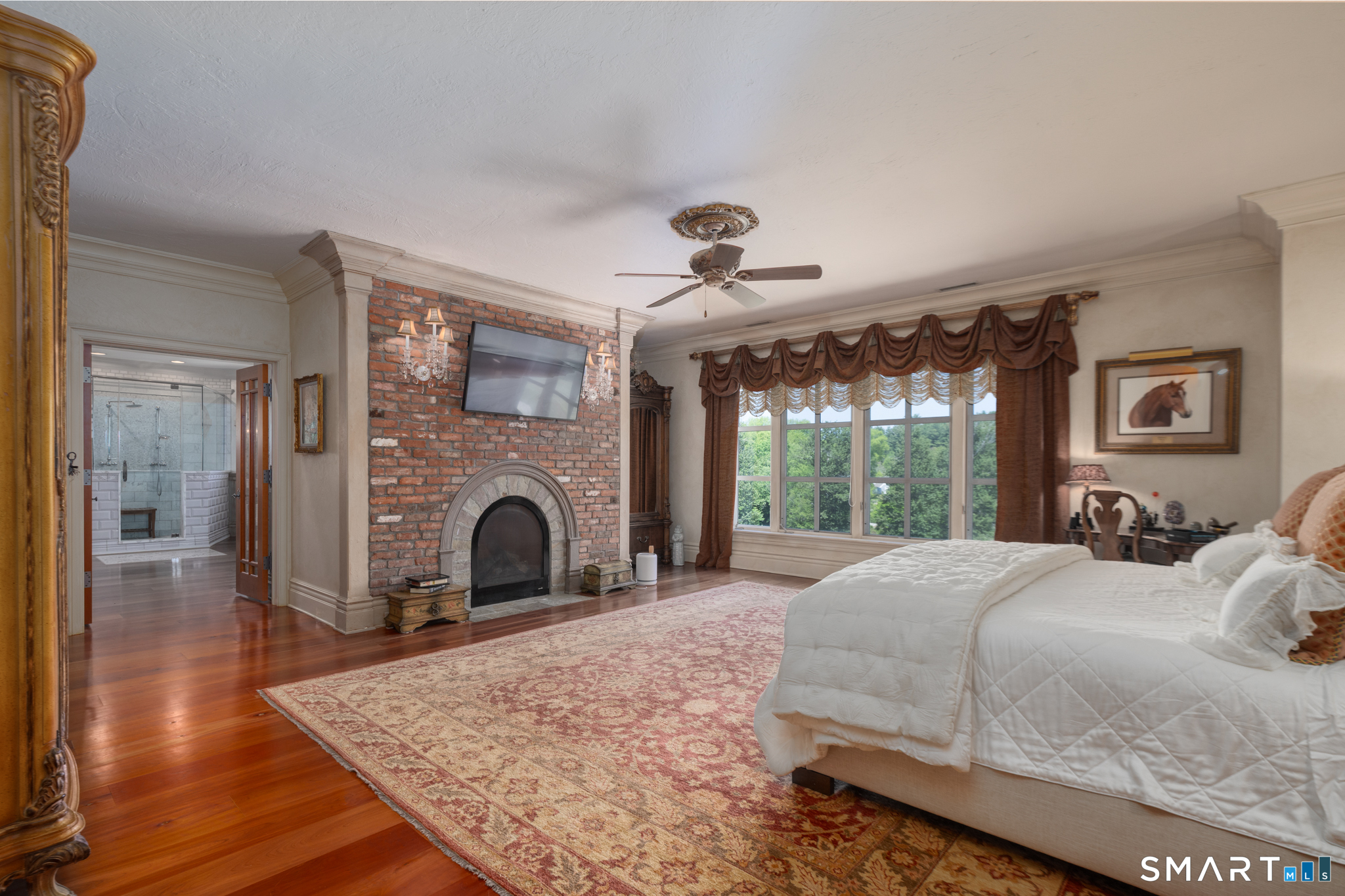 7 Equestrian Ridge Newtown, CT 06470 - Photo 23 of 40 a bedroom with a bed and a fireplace