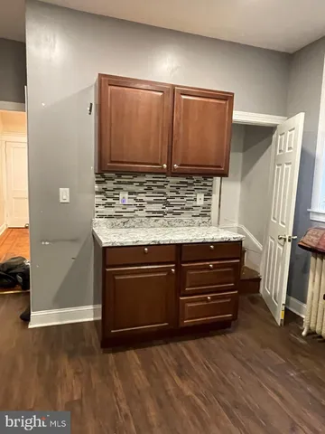 a kitchen with stainless steel appliances granite countertop a stove microwave and cabinets