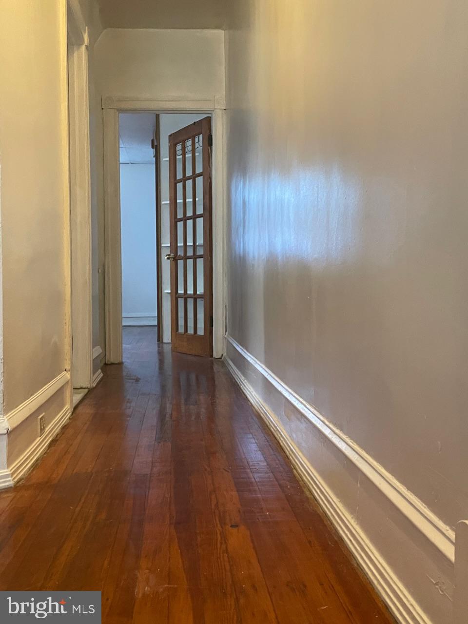 1115 West Wyoming Avenue Philadelphia, PA 19140 - Photo 17 of 33 wooden floor in an empty room with a window