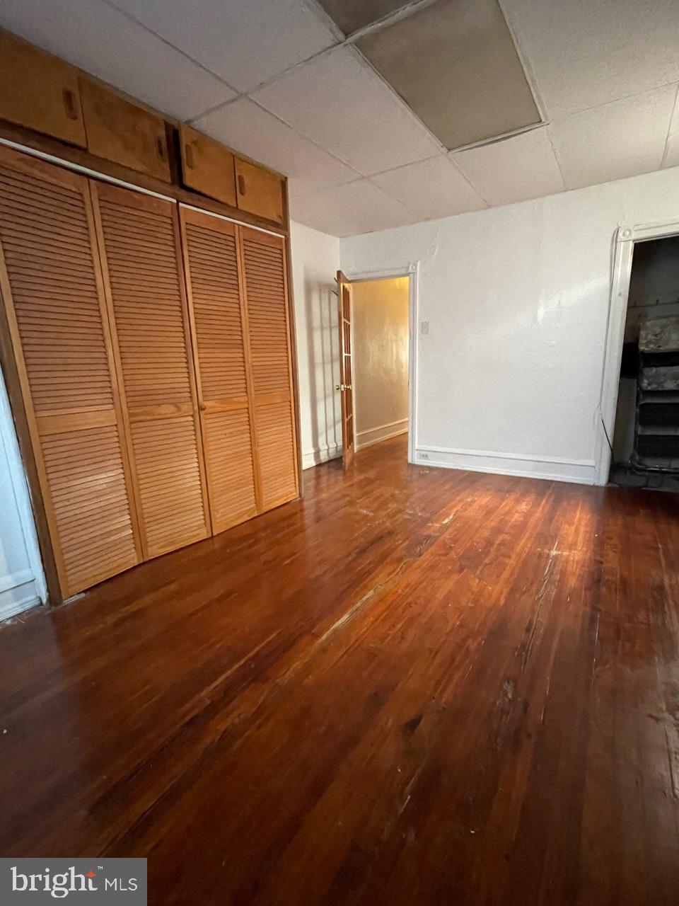 1115 West Wyoming Avenue Philadelphia, PA 19140 - Photo 19 of 33 a view of an empty room with wooden floor and a window