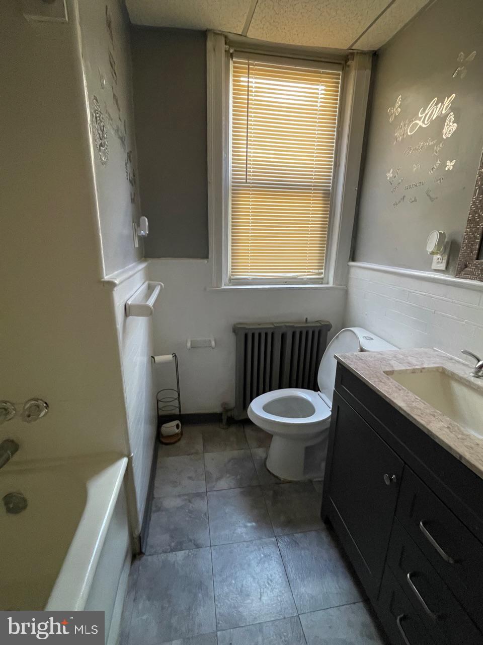 1115 West Wyoming Avenue Philadelphia, PA 19140 - Photo 22 of 33 a bathroom with a sink a toilet and a bathtub
