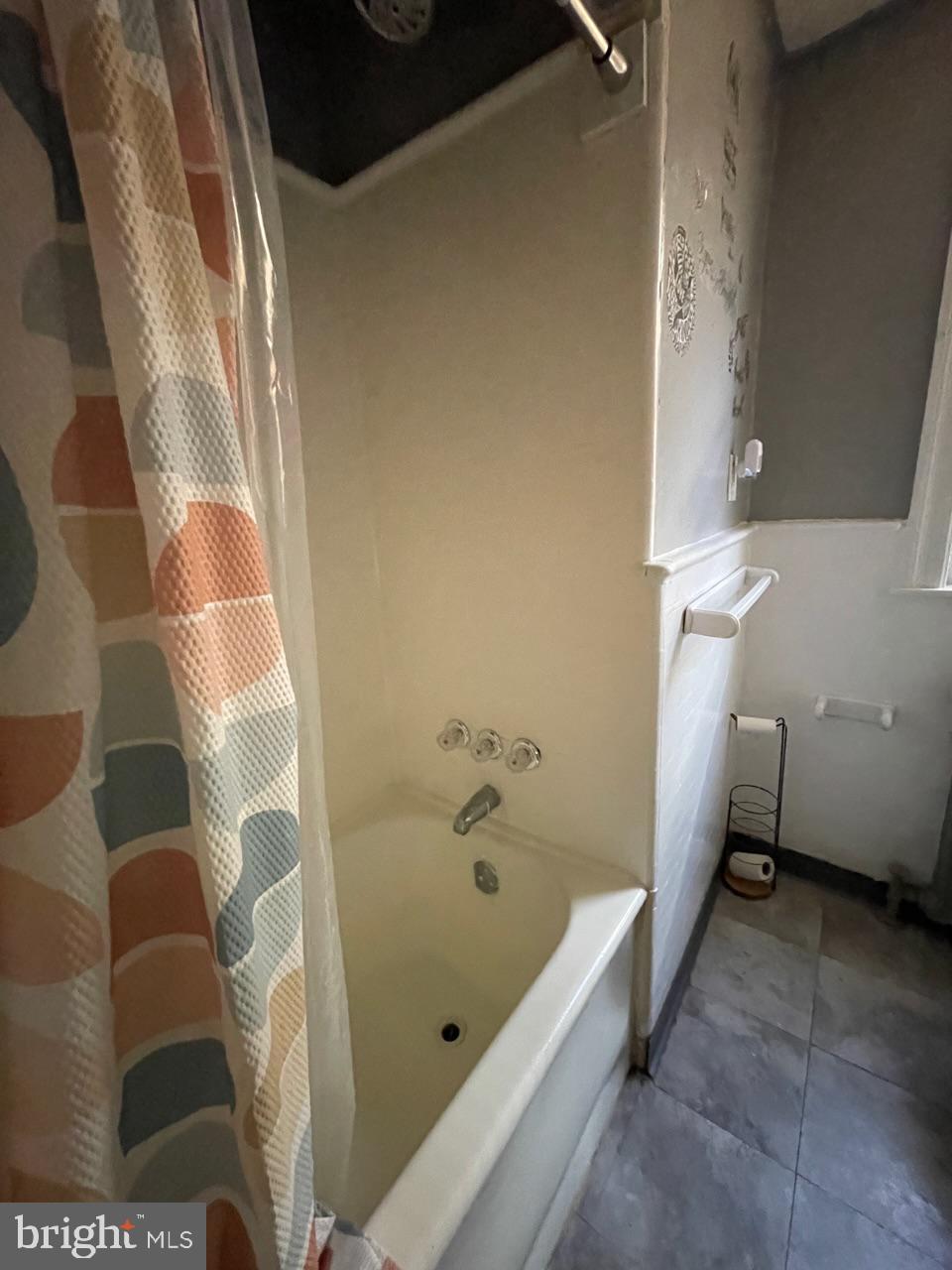 1115 West Wyoming Avenue Philadelphia, PA 19140 - Photo 23 of 33 a bathroom with a bathtub and shower