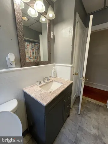 an empty room with wooden floor and closet