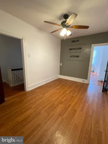 a view of a room with wooden floor and window