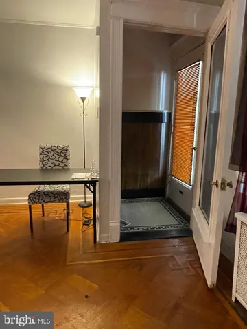 a view of an empty room with a chandelier fan