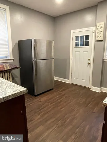 a kitchen with granite countertop wooden cabinets and a stove top oven