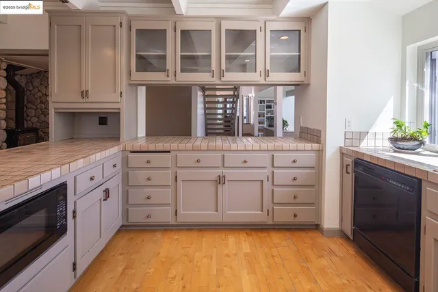 a kitchen with stainless steel appliances granite countertop a stove and cabinets
