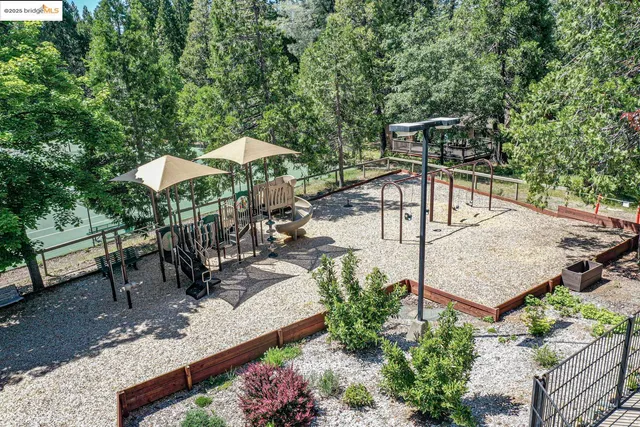 a aerial view of a house with a yard and trees