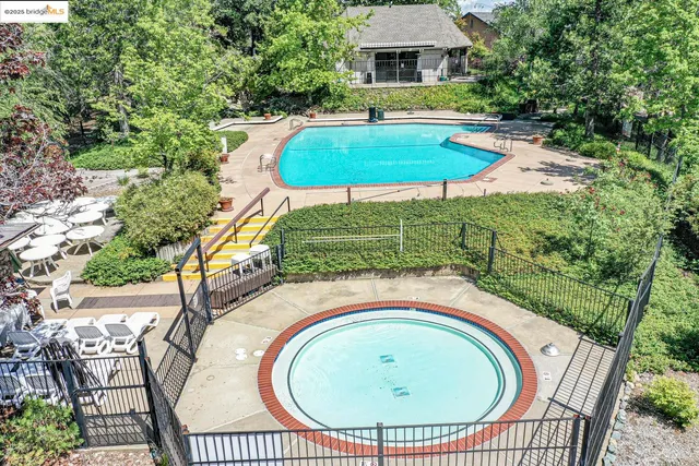 an aerial view of a house with a yard and trees