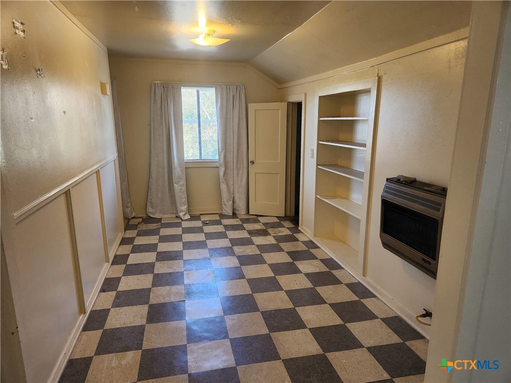 1205 South 17th Street Temple, TX 76504 - Photo 2 of 7 a view of a storage & utility room with a black white checkered floor