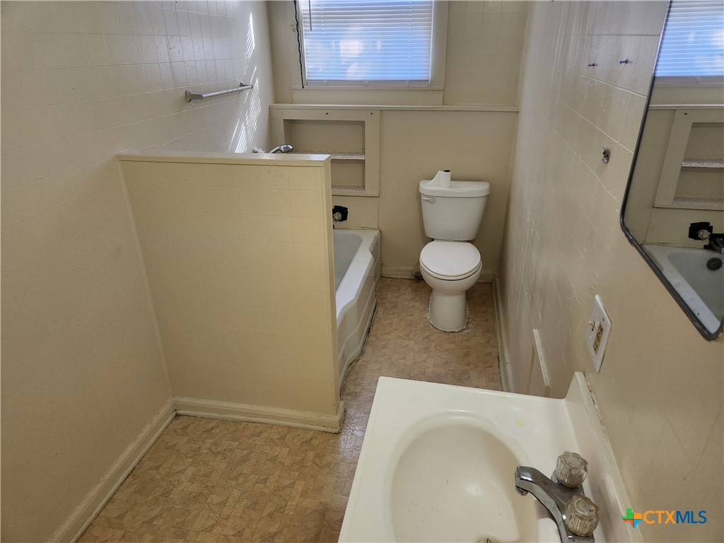 1205 South 17th Street Temple, TX 76504 - Photo 5 of 7 a bathroom with a sink and a toilet