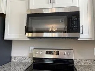 a kitchen with a stove and a microwave