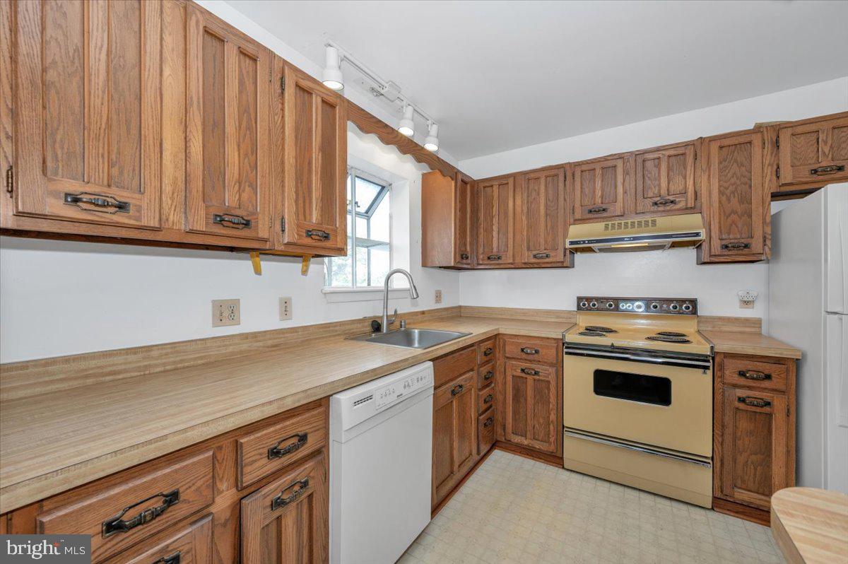 1300 Holliben Road Severna Park, MD 21146 - Photo 14 of 69 a kitchen with a sink stove and cabinets