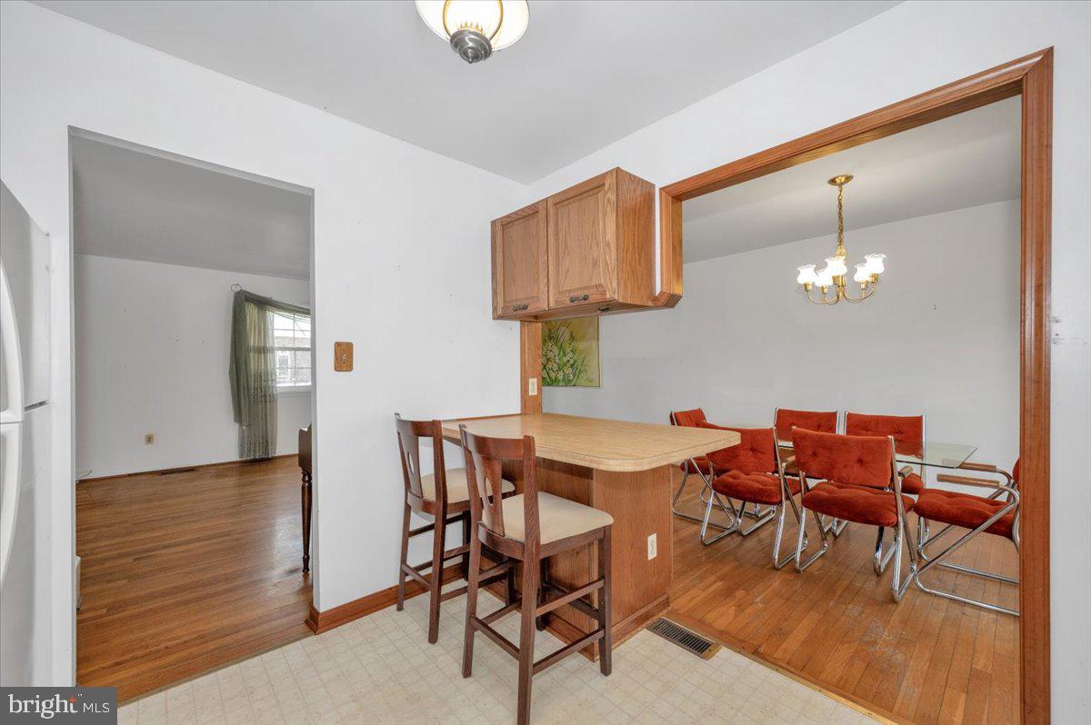 1300 Holliben Road Severna Park, MD 21146 - Photo 16 of 69 a view of a dining room with furniture and wooden floor